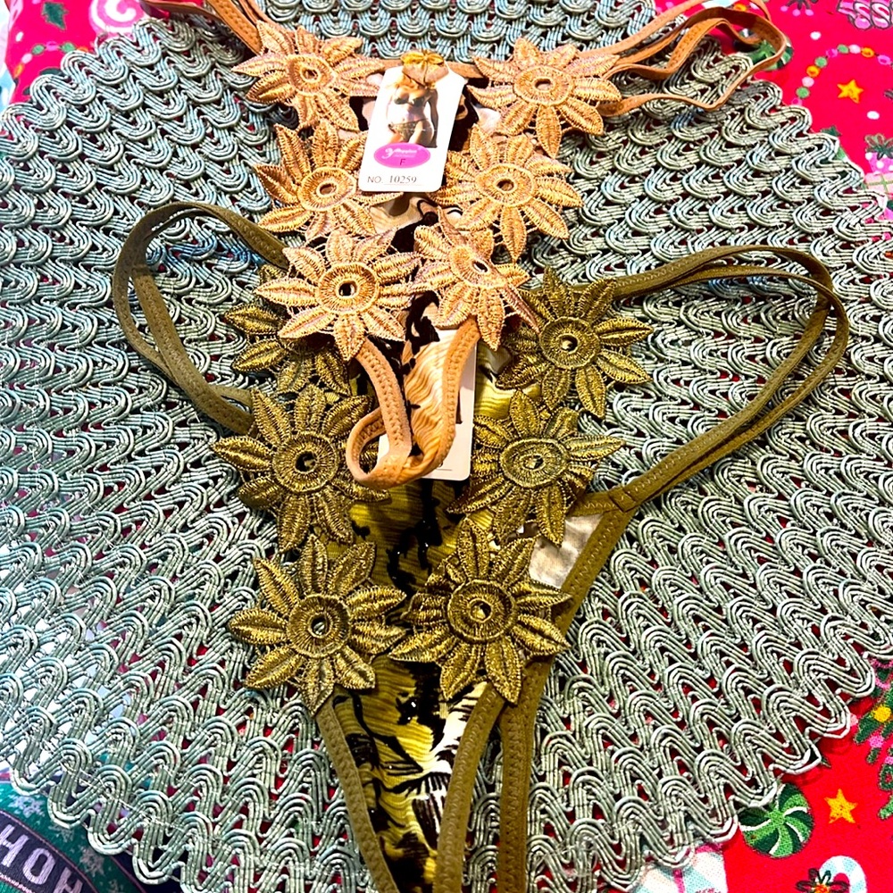 NWT 2 pairs unique thongs. Fits sizes small to medium